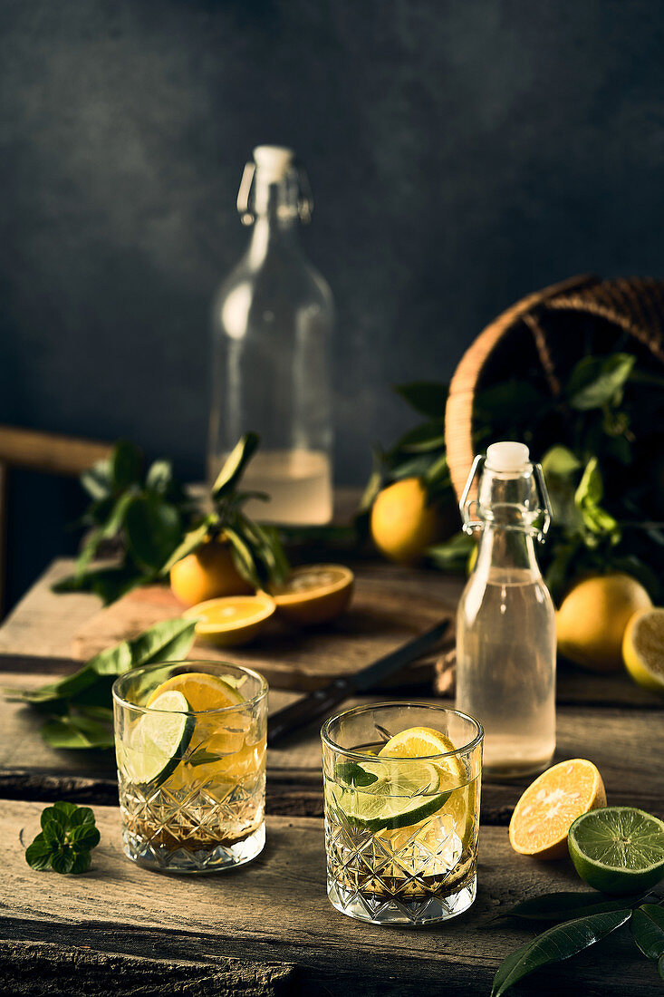 Water with lemon and lime slices in glasses