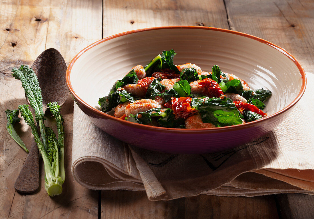 Gnocchi with black cabbage, dried peppers and tomato sauce