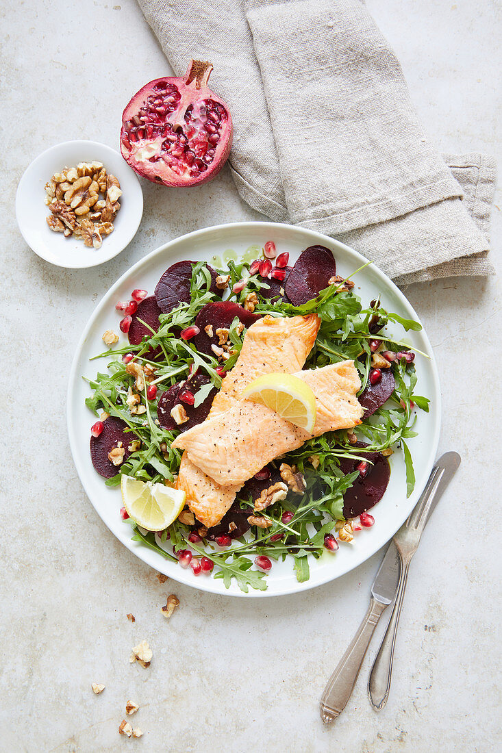 Roast salmon on rocket salad with beetroot and pomegranate seeds