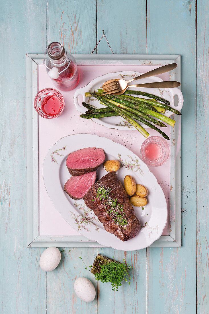 Fillet of beef with roasted asparagus and potatoes on tray