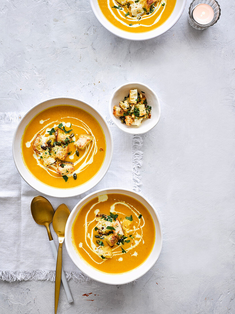 Creamy carrot soup with garlicky seeded croutons