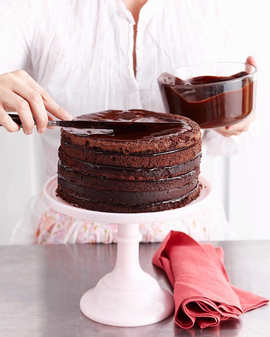 Preparing sixlLayer chocolate cake