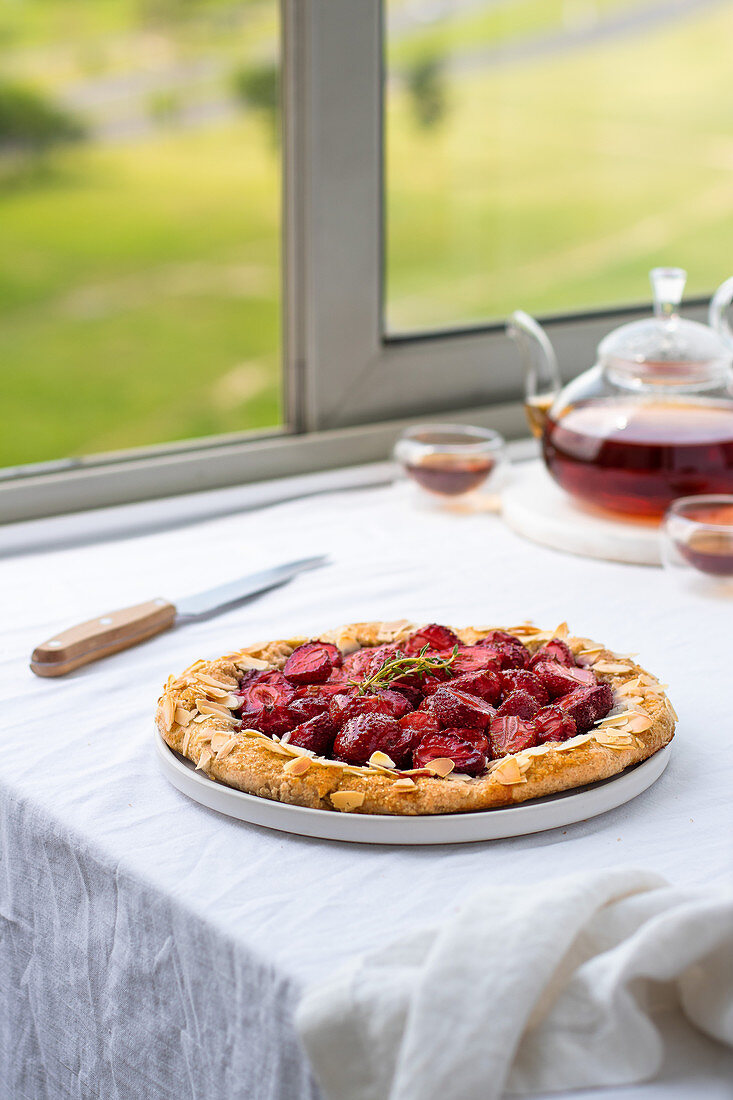 Strawberry galette on a table by a window