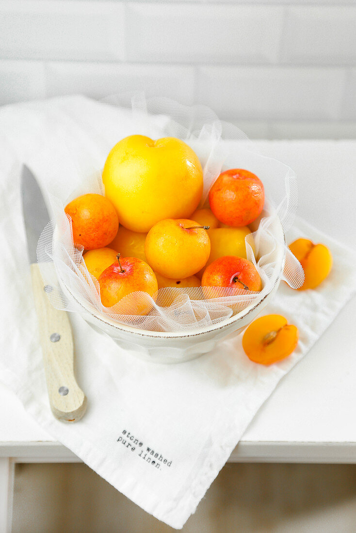 Fresh yellow plums in a bowl