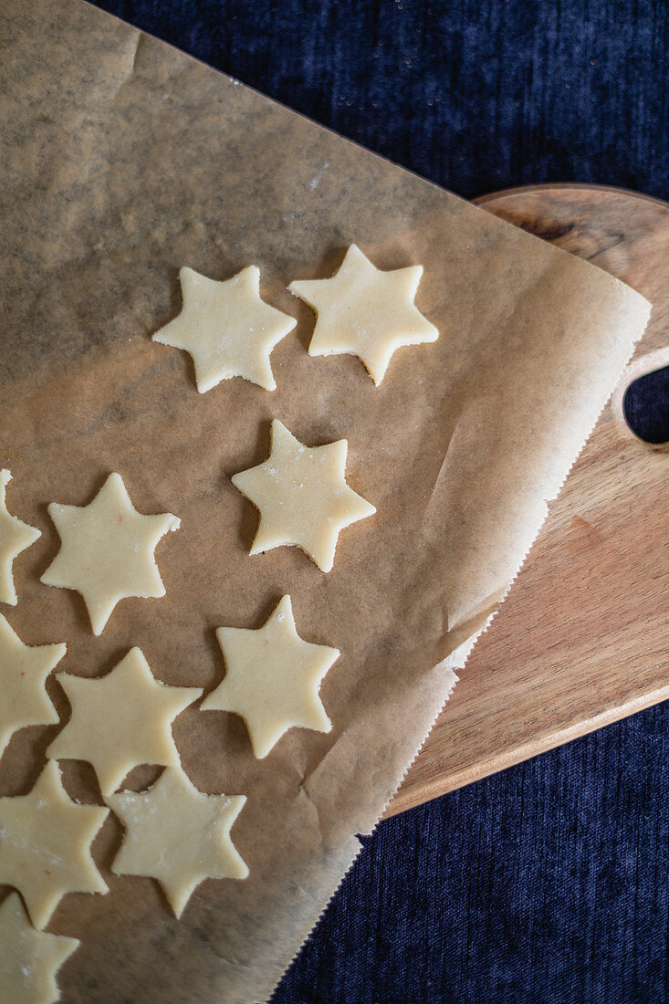 Unbaked pastry stars on parchment paper