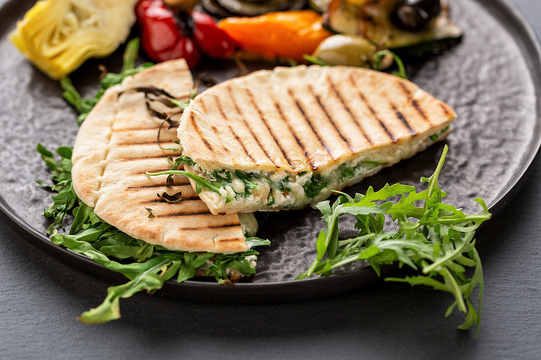 Mediterranean pita bread filled with cheese with grilled vegetables