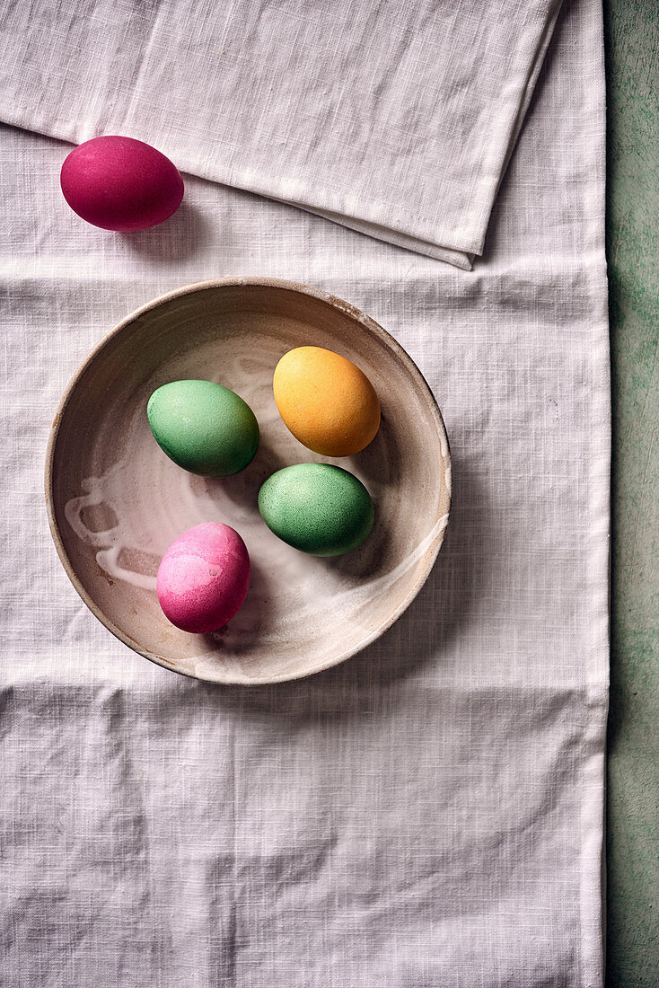 Colored Easter eggs in a ceramic bowl
