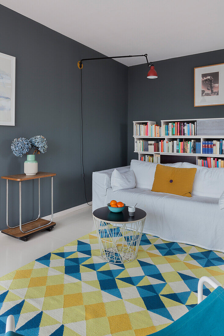 Lounge with dark walls and patterned carpet