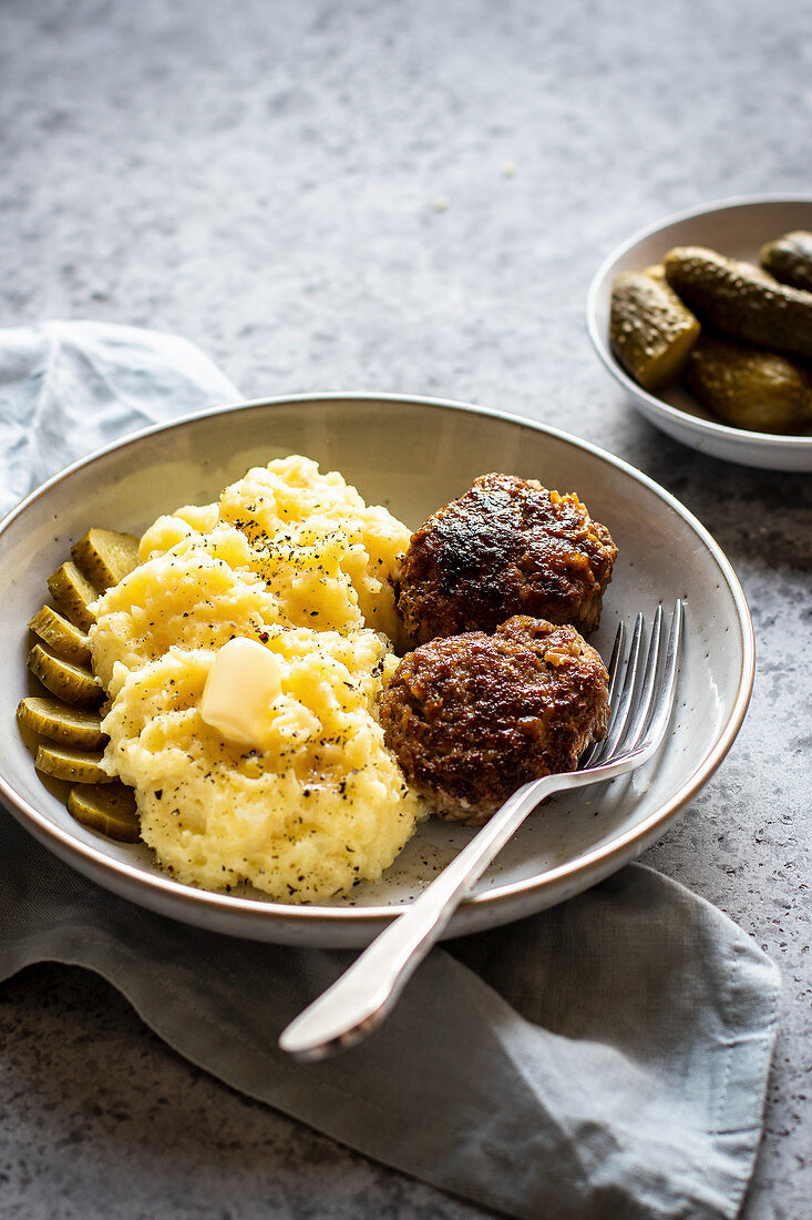 Burgers with mashed potatoes and pickles