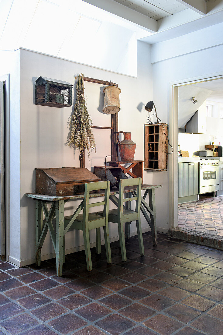 Flea-market finds on old console table and mint-green chairs in hallway