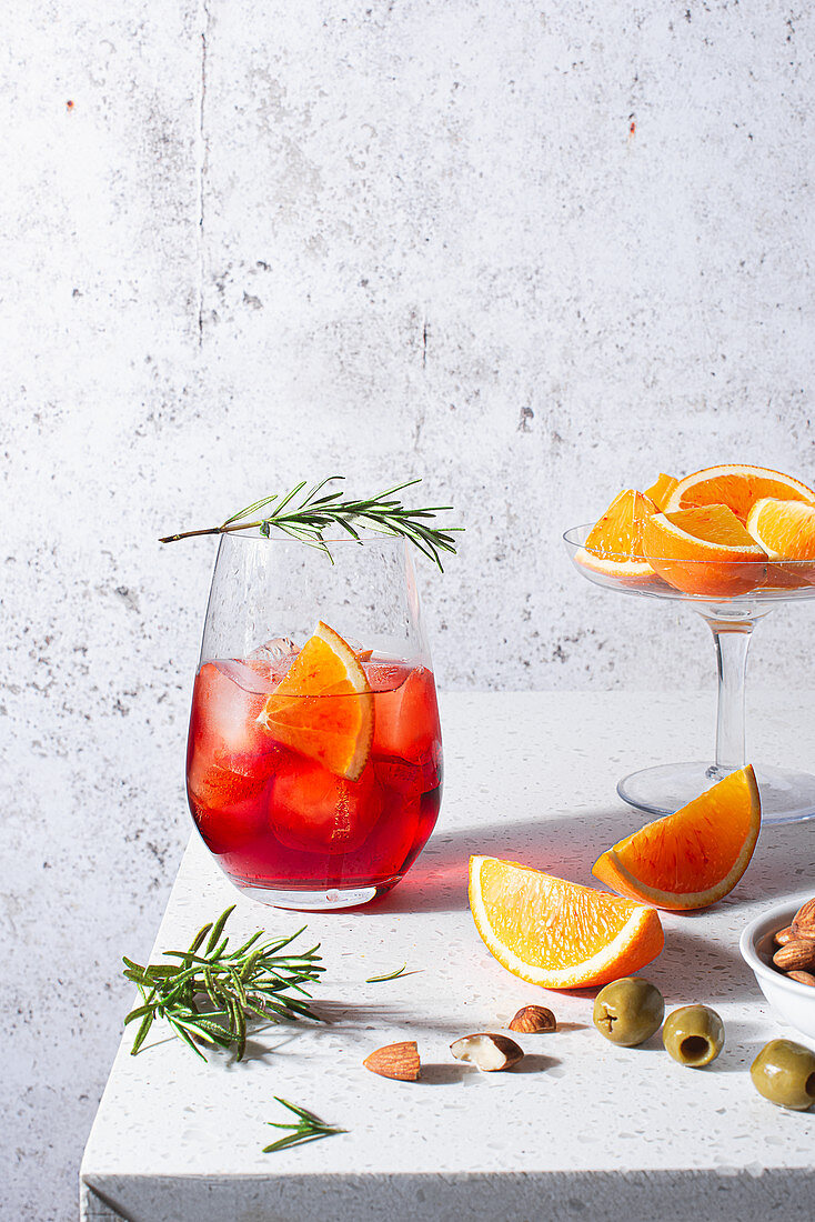 Negroni cocktail with oranges and rosemary