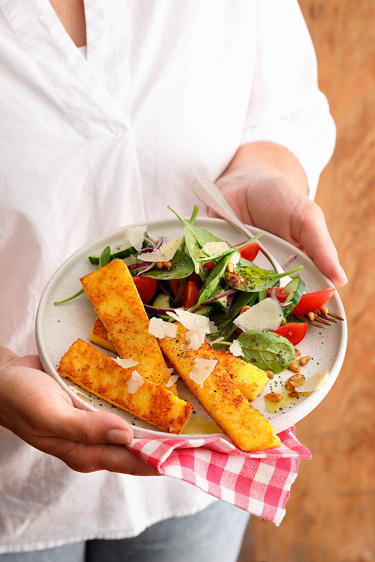 Polenta sticks with salad and Parmesan cheese