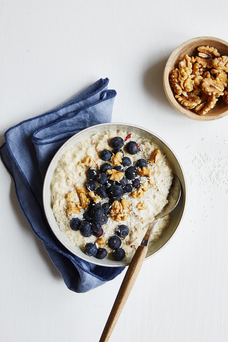 Bircher muesli with a coconut drink, blueberries and walnuts