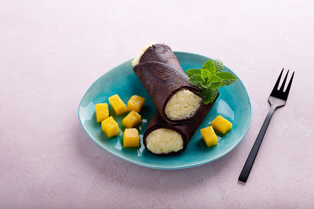 A chocolate pancake filled with mango mousse