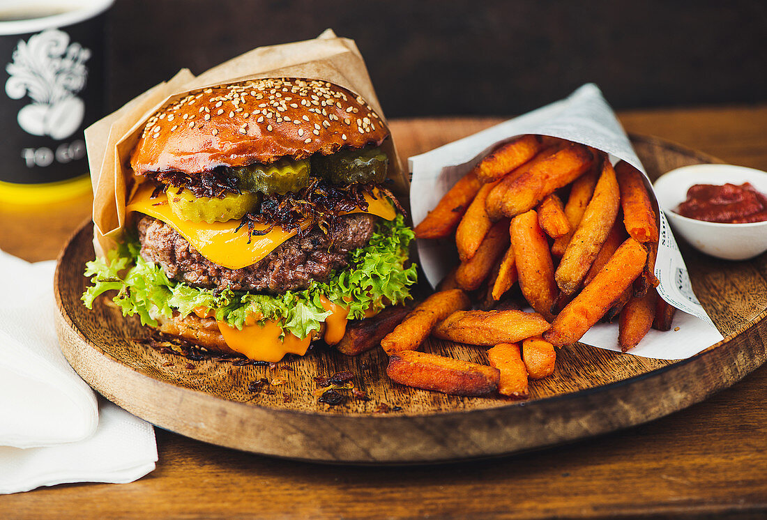 Burger with fried onions, cheese and lettuce leaf