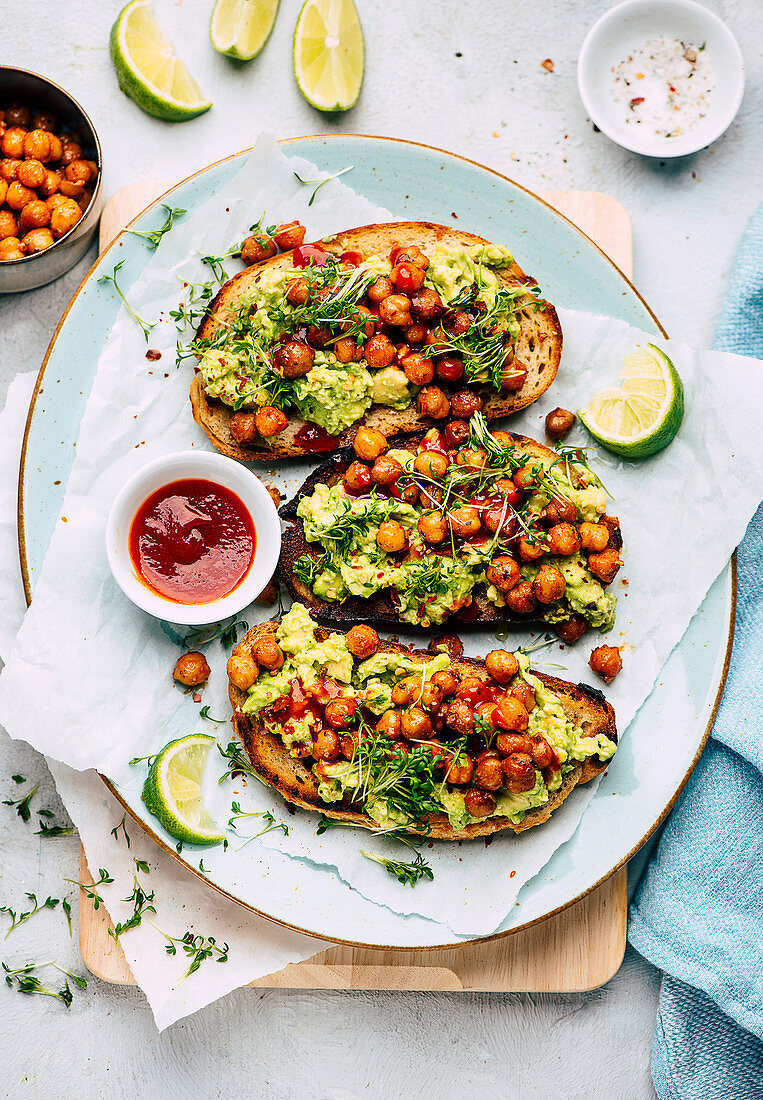 crostini with avocado, chickpeas, and sprouts