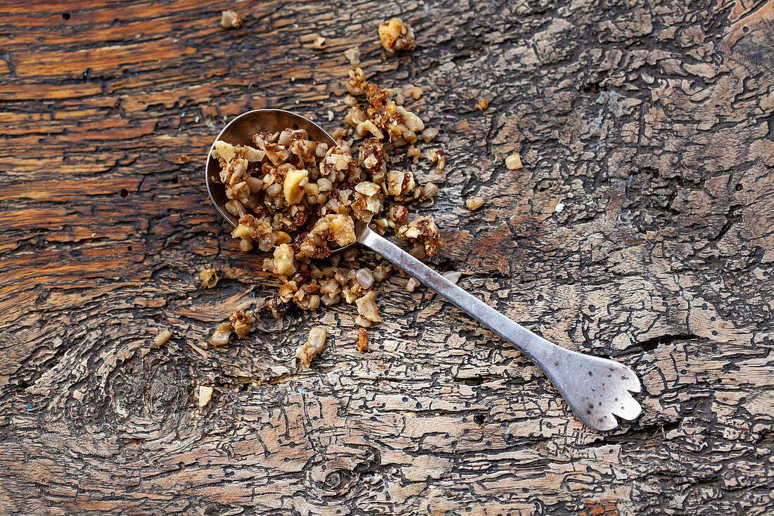 Granola with nuts in vintage silver spoon