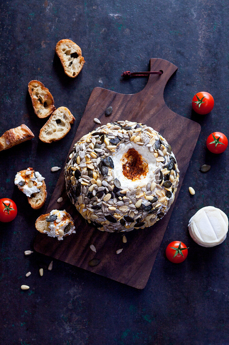 Goat's cheese ball with tomatoes and seeds