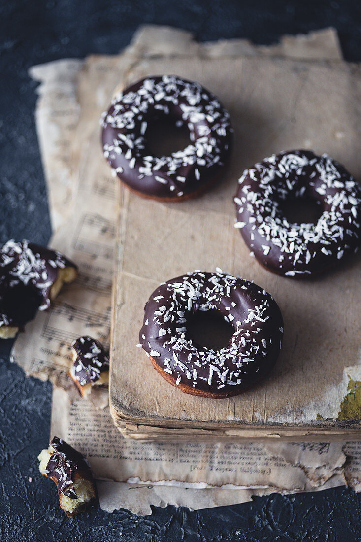 Donuts with chocolate glaze and coconut shreds.