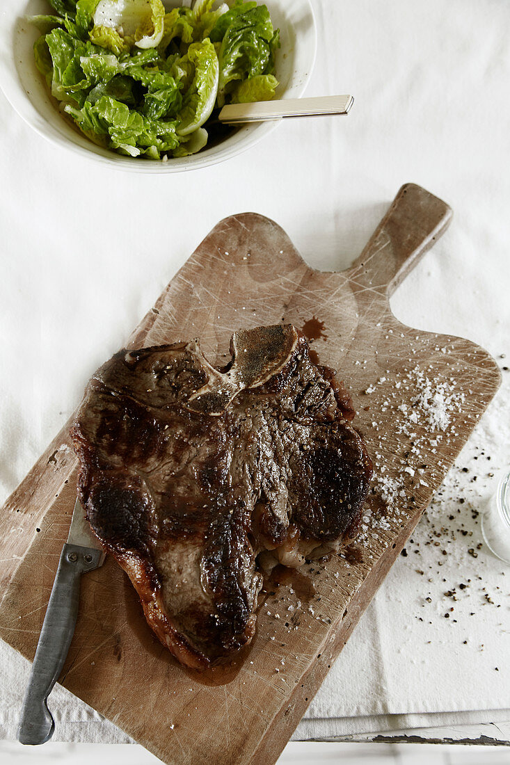 Bistecca alla Fiorentina (beef steak) on a cutting board