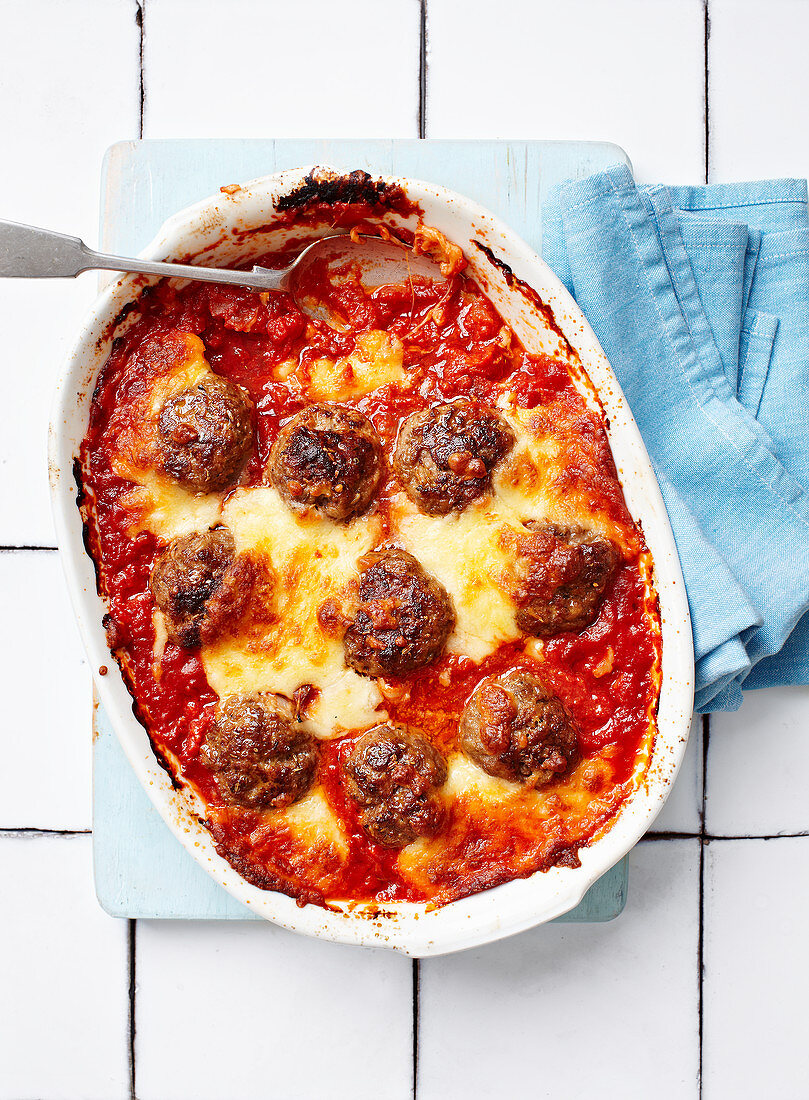 Italian baked meatballs in tomato sauce with cheese