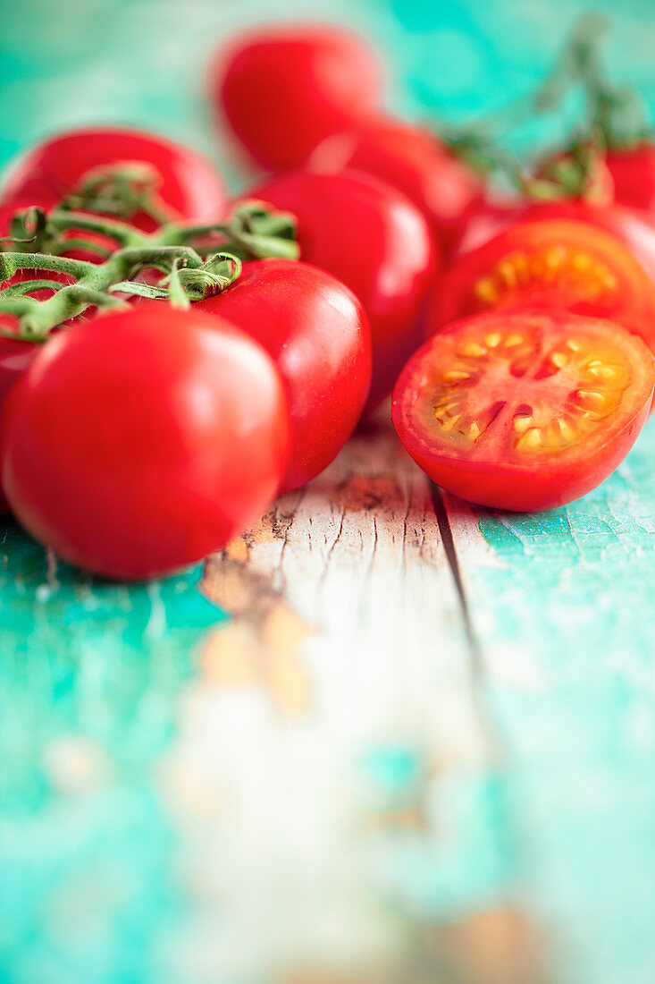 Vine tomatoes on a turquoise wooden background