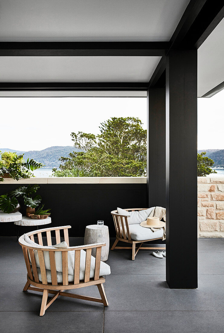 Lounge furniture on roofed terrace with panoramic view