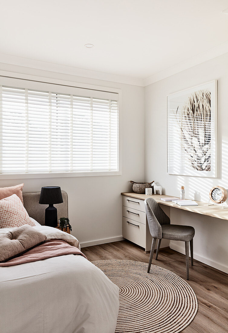 Desk in guest room decorated in beige, white and ecru