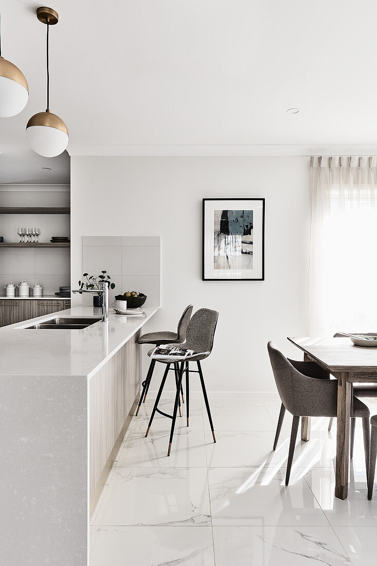 Open-plan kitchen and dining table in bright, modern living room