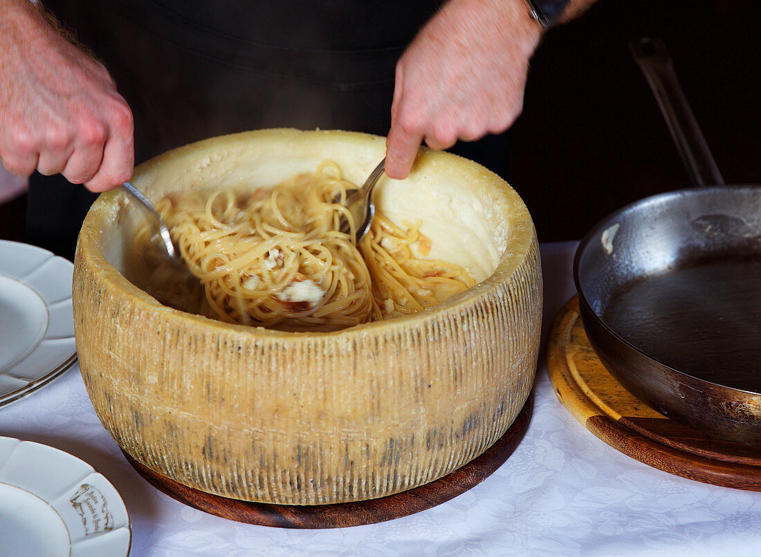 Pasta served in a hollowed-out pecorino cheese wheel