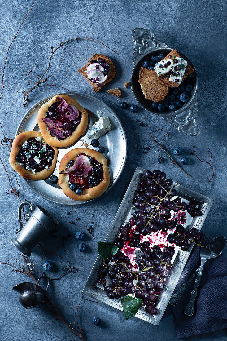 Blueberry pizzas with grapes and pears in blueberry juice