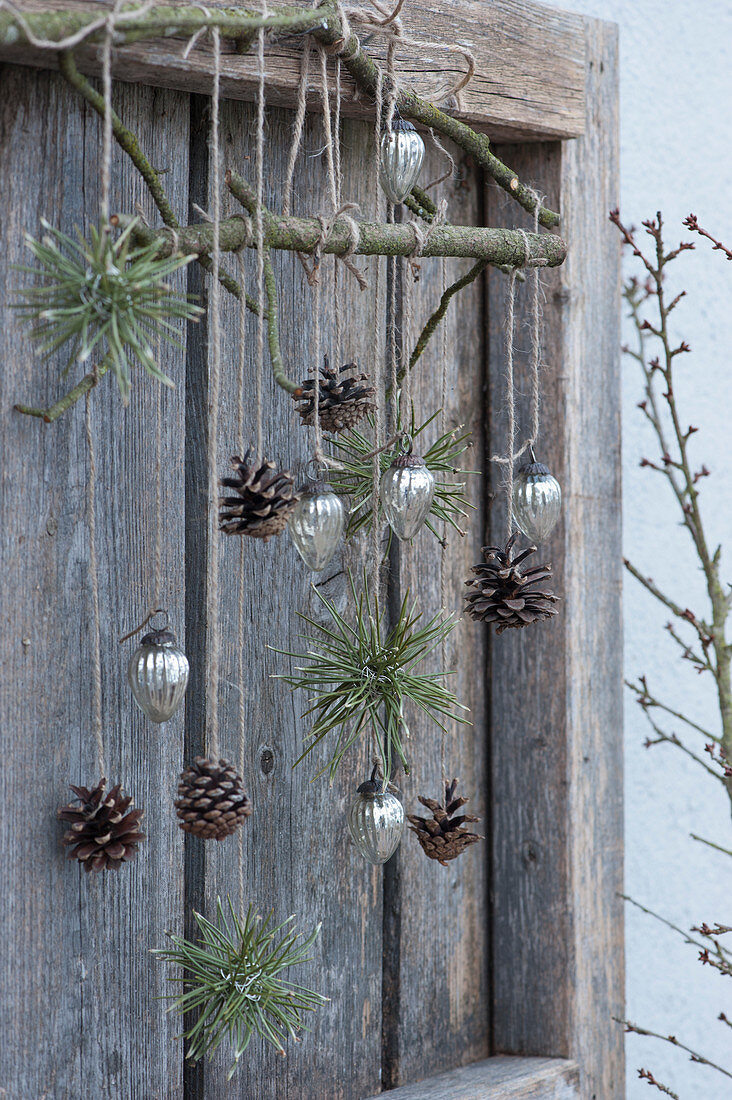 Mobile made of cones, Christmas tree decorations and pine needles