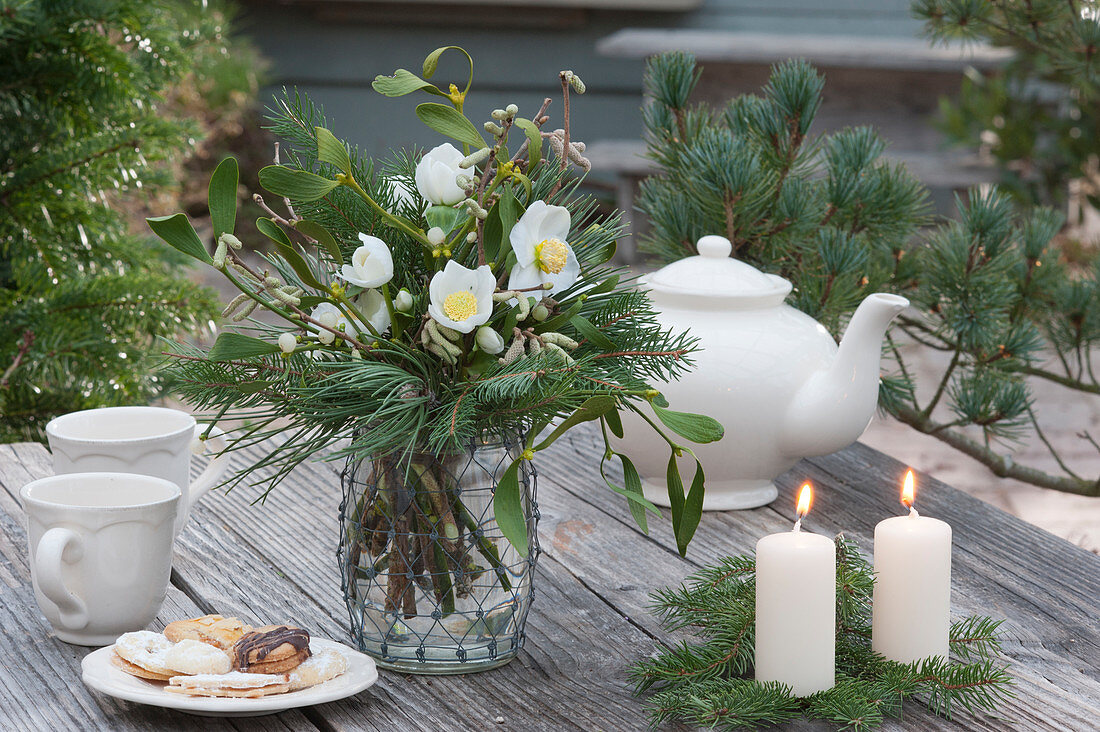 Christmas bouquet of Christmas rose and branches of pine, spruce, mistletoe and hazelnut