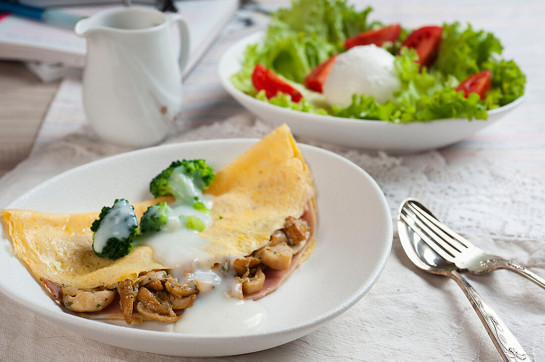 Omelette stuffed with porcini mushrooms and cooked ham