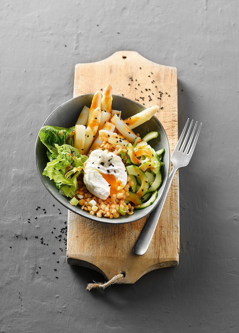 Vegetarian asparagus bowl with poached eggs and red lentils