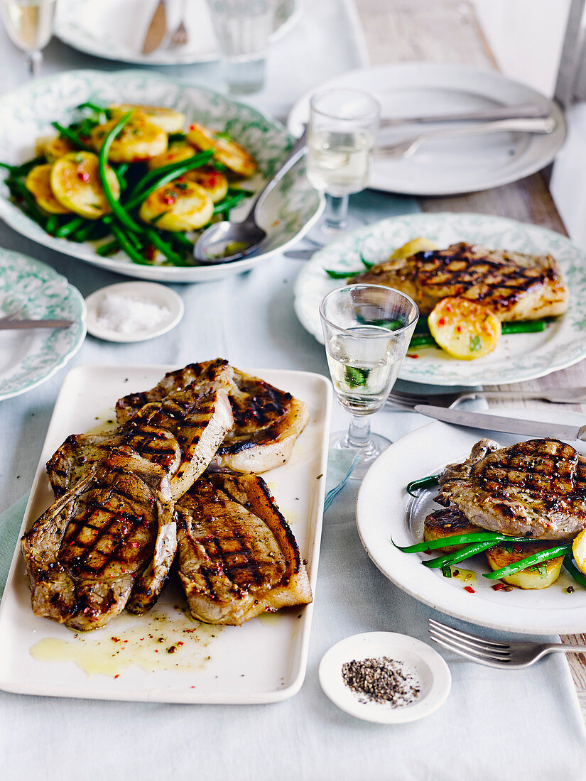 Herb-brined pork chops with spiced fried potatoes and green beans