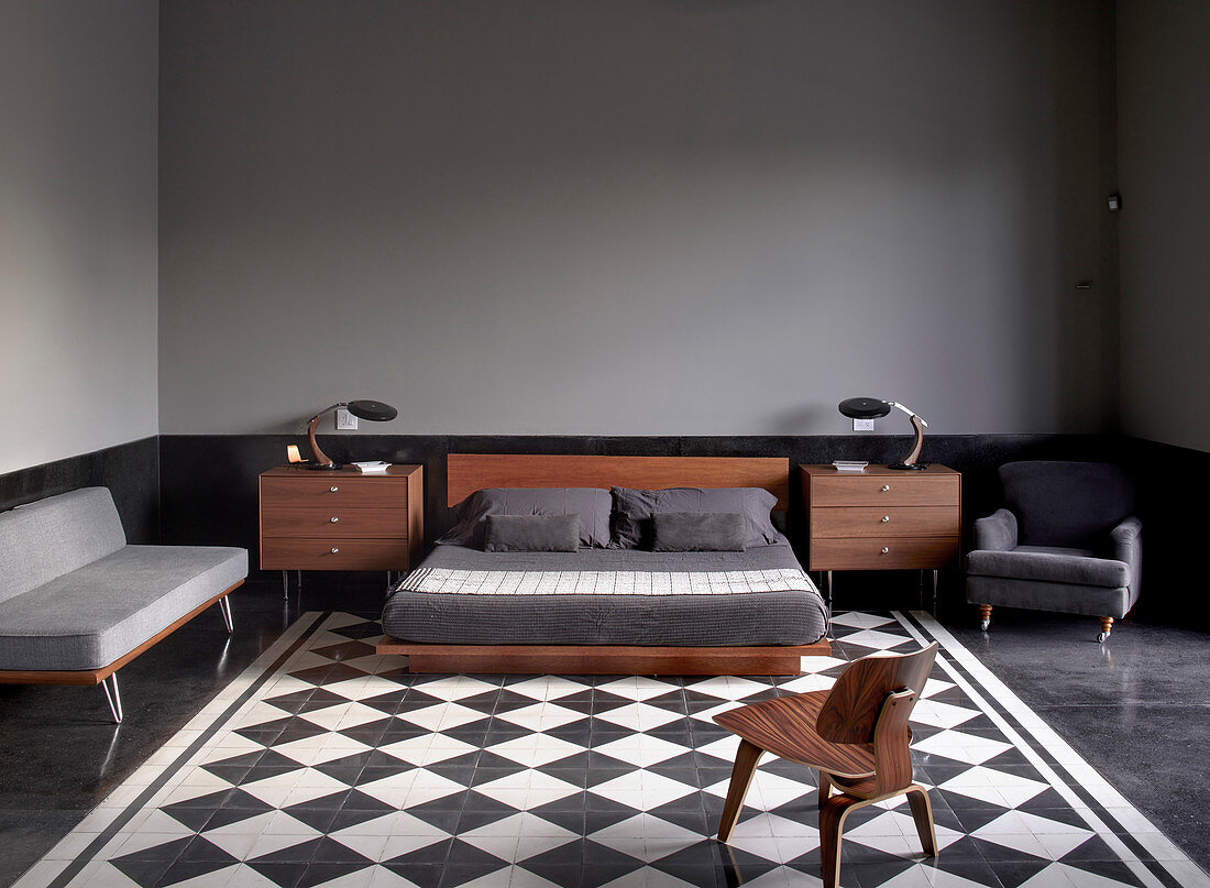 Mid-century modern furniture in masculine bedroom with chequered floor