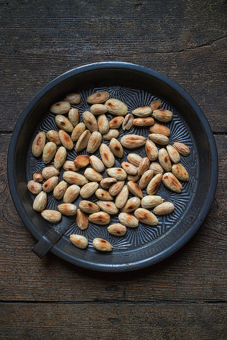 Toasted almonds in a round metal tray