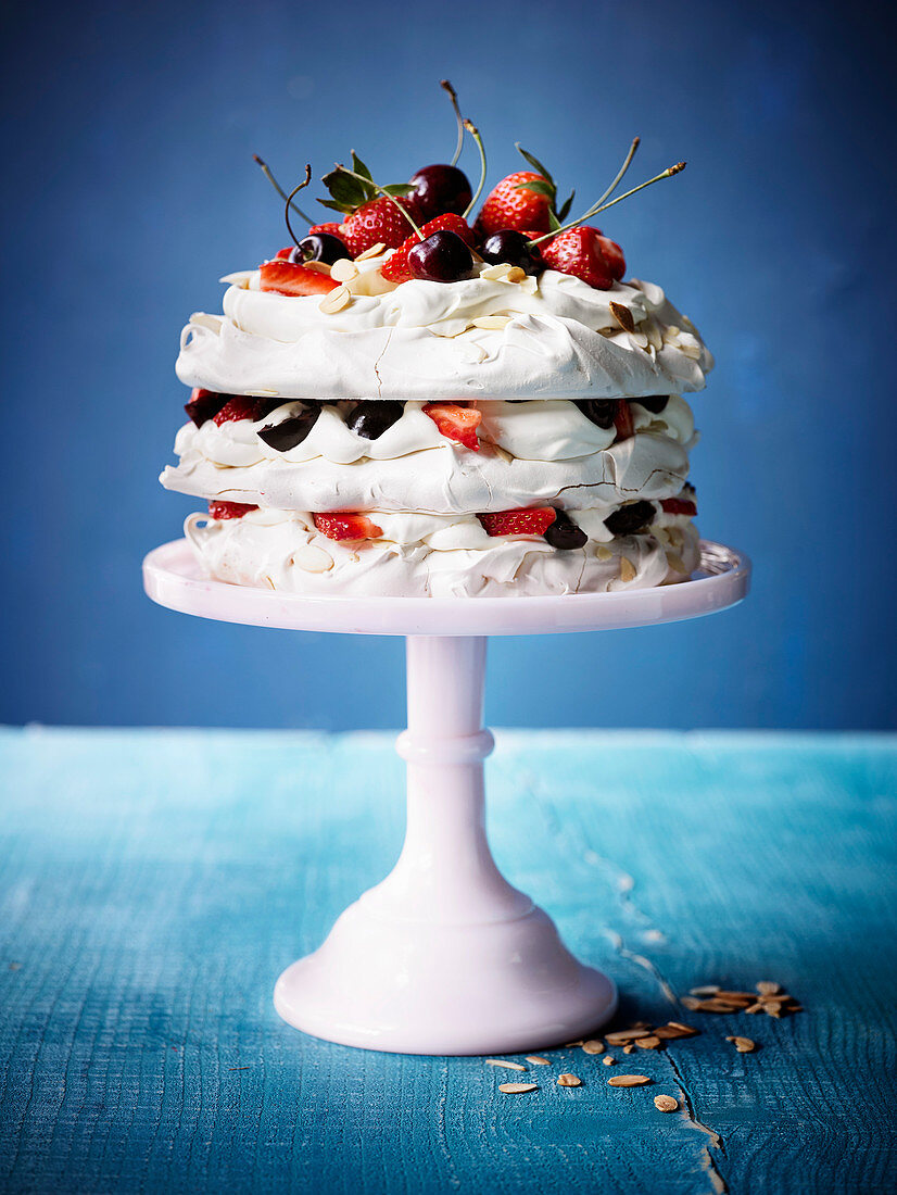 Amaretto meringue cake with strawberries and cherries
