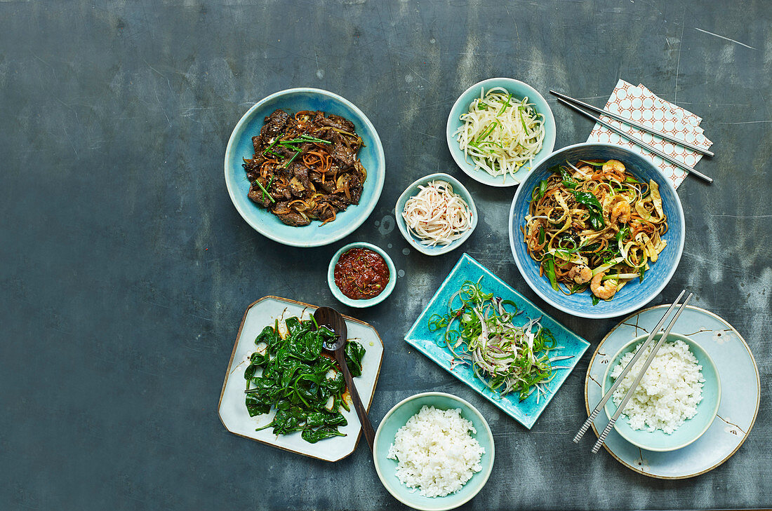 Korean dishes - Bulgogi, Jao Chae noodles with prawns, radish pickle, Ssamjang, Sesame spinach, Beansprouts