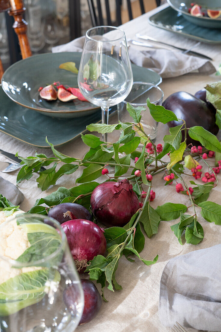 Set table with centrepiece of vegetables for harvest festival