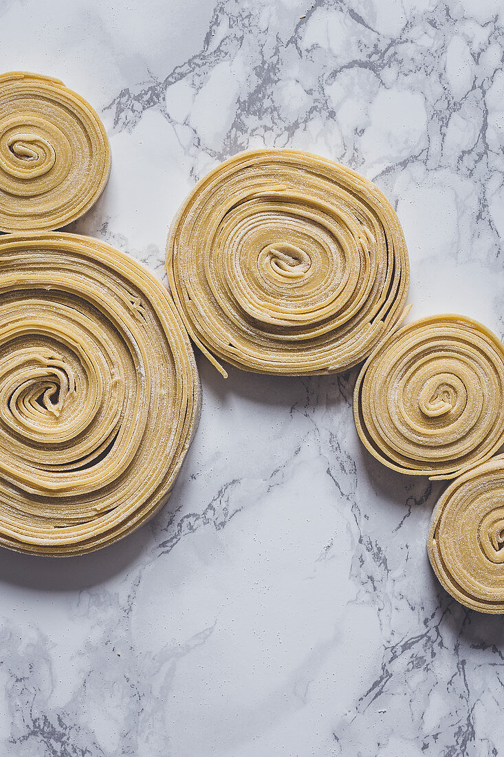 Fresh uncooked pasta swirls
