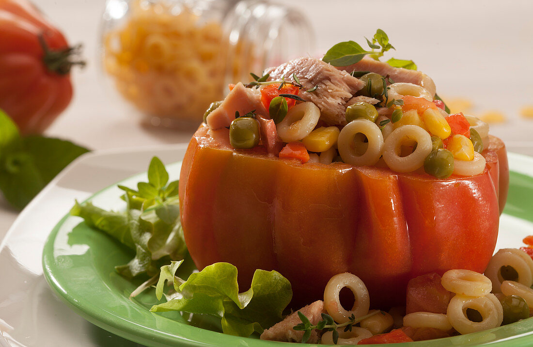 A stuffed beefsteak tomato filled with tuna, pasta and vegetables