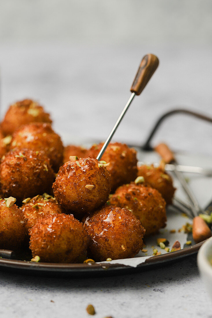 Fried goat cheese balls with pistachios and truffle honey