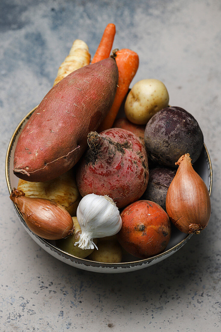 Raw root vegetables in a bowl