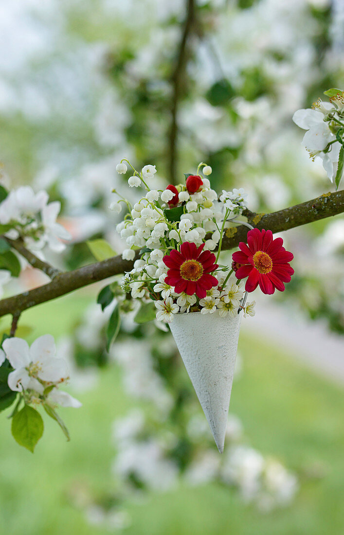 Posy of lily-of-the-valley, red dahlias and saxifrage