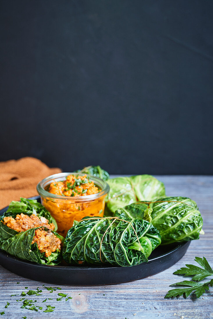 Savoy cabbage roulade filled with vegetables and walnuts and served with pumpkin sauce