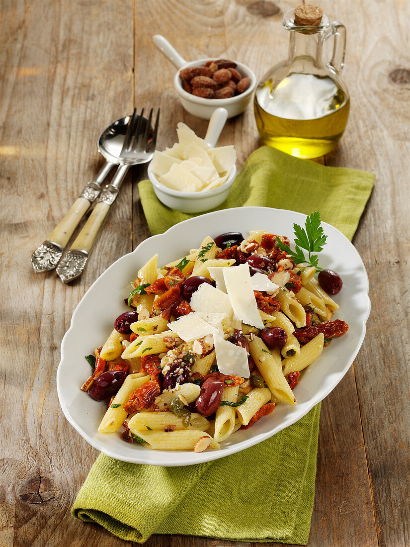 Italian pasta salad with capers, dried tomatoes and salted almonds