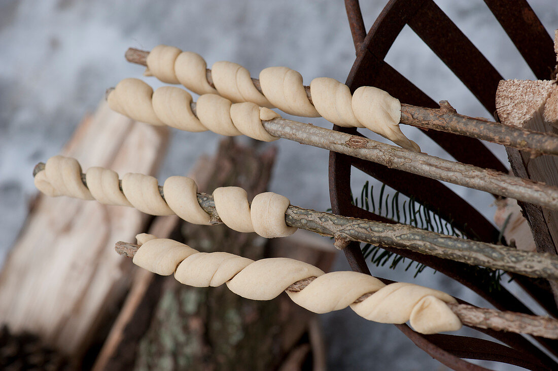 Bread dough for stick bread wound around twigs