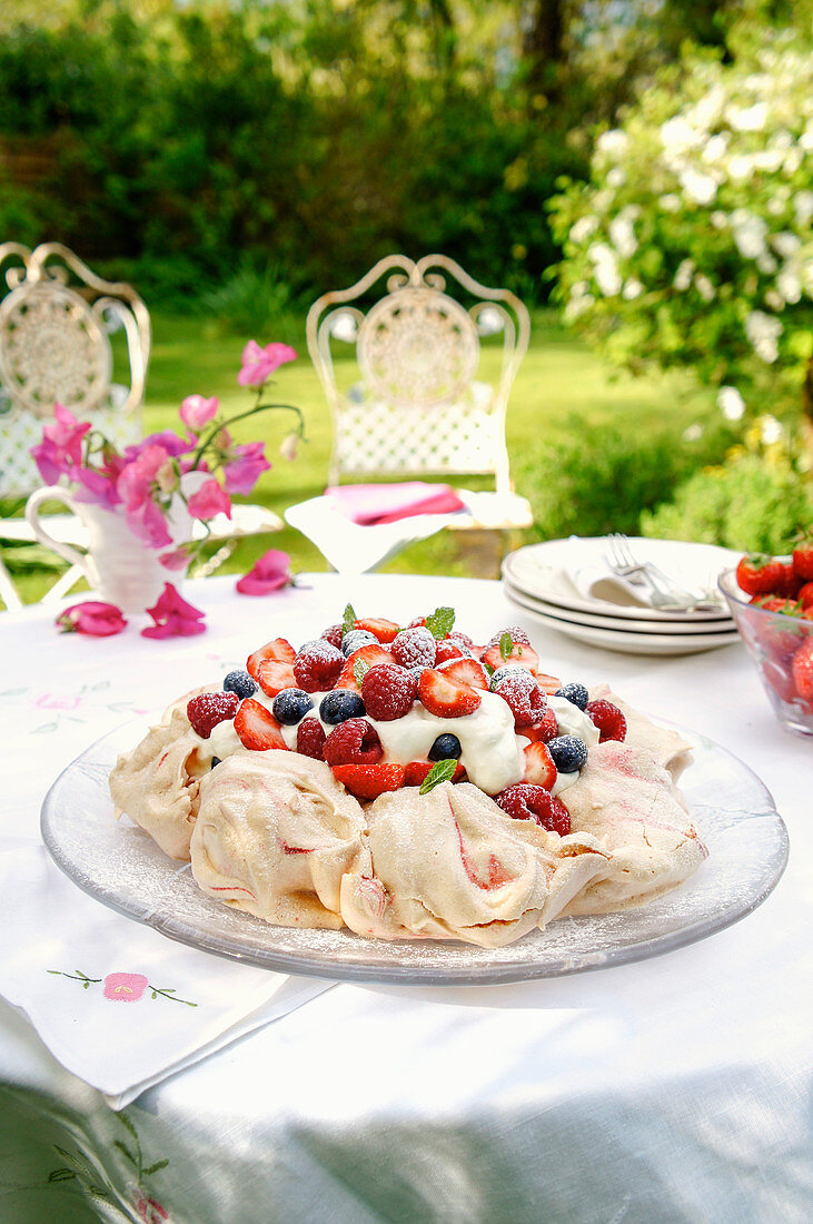 Light summer pavlova on a table in the garden